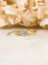 side cluster engagement ring and two curved wedding bands