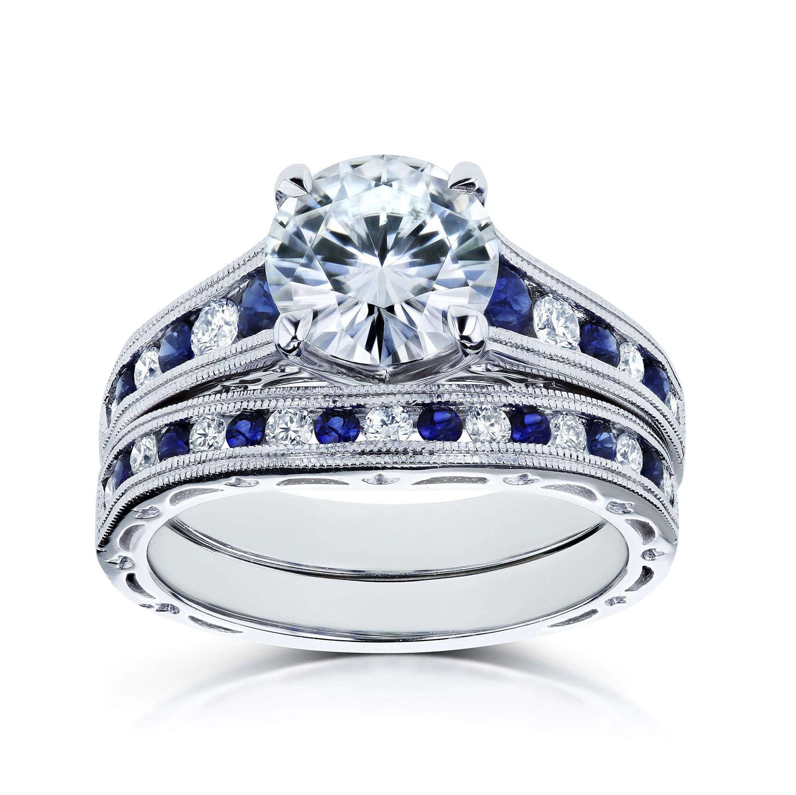 A solid 14k white gold engagement ring and wedding band set with a large round brilliant-cut center moissanite, channel-set round white diamonds and deep blue sapphires