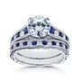 A solid 14k white gold engagement ring and wedding band set with a large round brilliant-cut center moissanite, channel-set round white diamonds and deep blue sapphires