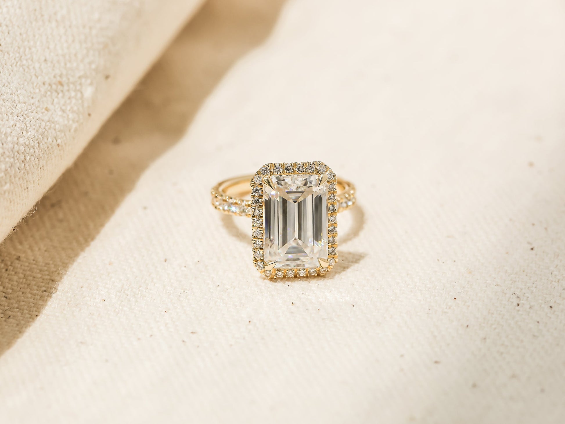 Kobelli Grown Emerald-Cut All-Diamond Sustainable Gold Engagement Ring - angled shot on canvas