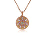 A rose gold circular pendant necklace featuring a floral mandala design with a central round diamond and surrounding marquise-cut diamonds in yellow, purple, and white, suspended from a delicate rose gold chain on a white background.