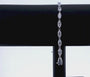 slow spinning video of marquise-cut diamond tennis bracelet - hanging off black display stand with white background