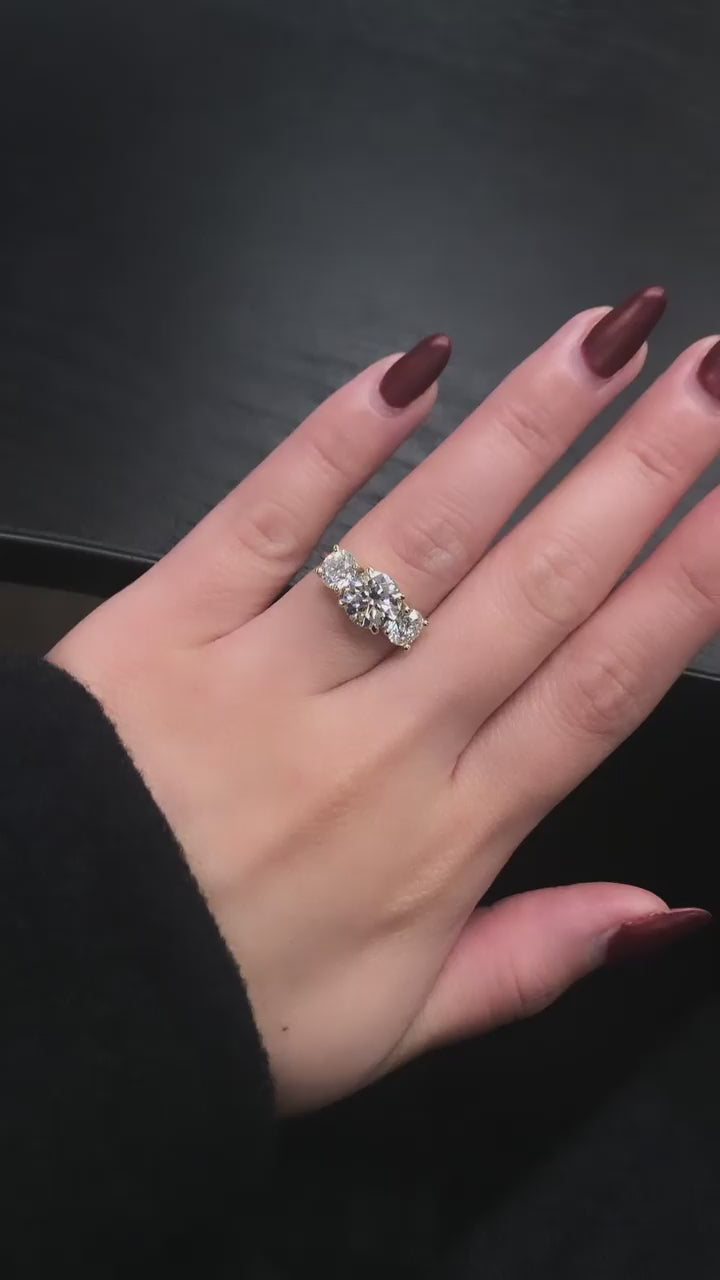 video of 2.5 Carat Moissanite Round 3-Stone Caitlin Ring on a hand