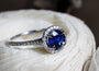 White diamonds line the halo as well as the band of the ring