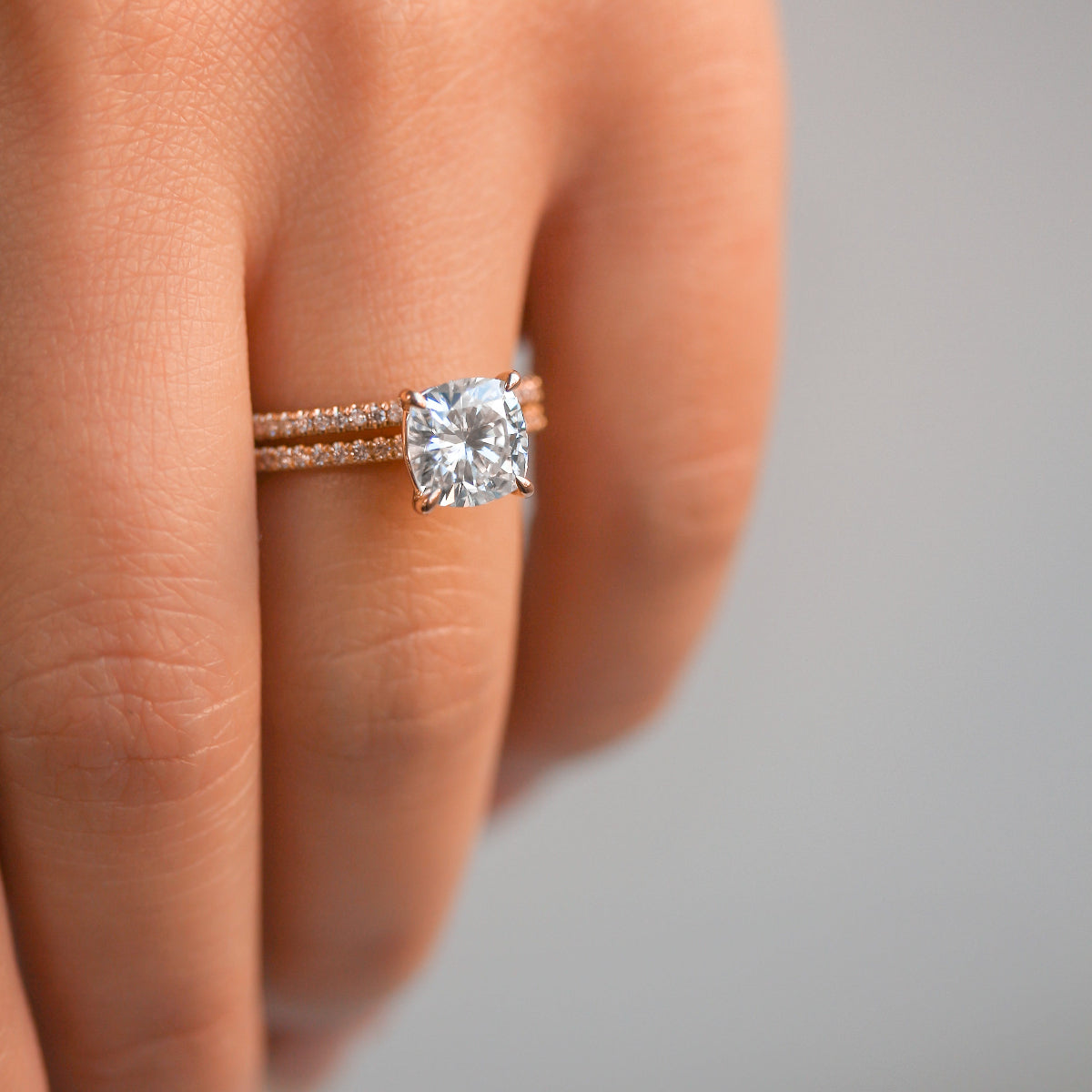 Cushion Petite Bridal Set on a hand - slender bands with a contrasting last center