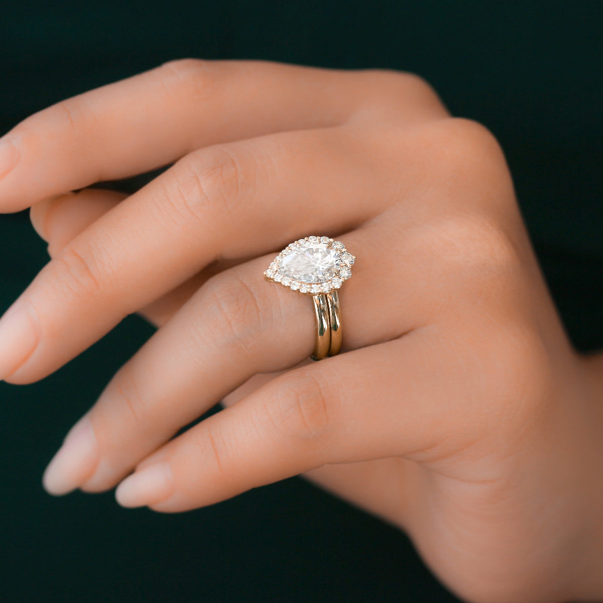 Pear shaped rococo halo ring in yellow gold